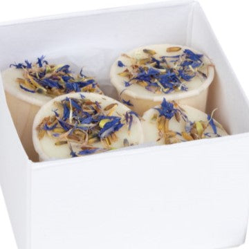 A white box containing four bath melt bars, each topped with a layer of dried lavender flowers.
